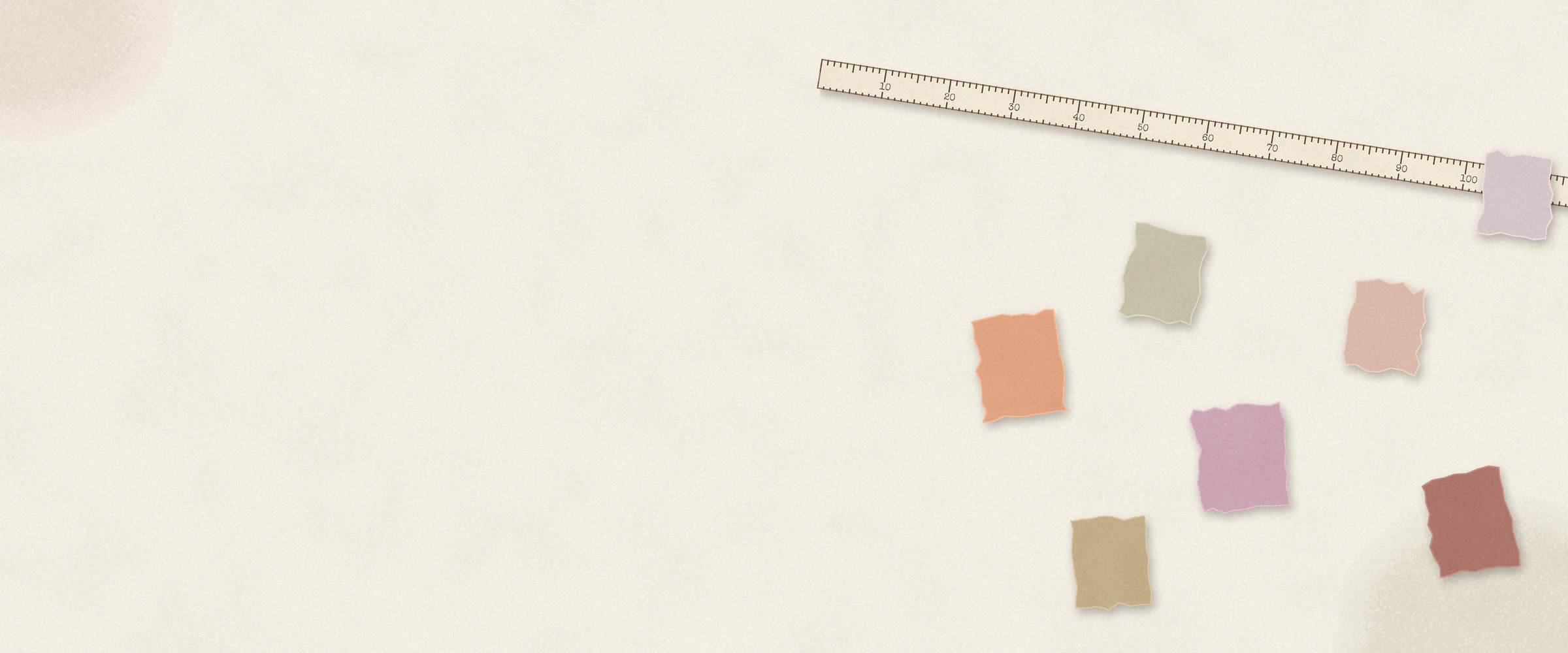 A ruler lies diagonally above scattered coloured paper squares on the right of a cream banner. Ruler labels read “10, 20, 30, 40, 50, 60, 70, 80, 90, 100”.