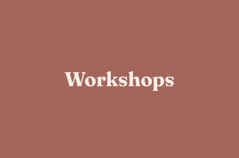 Cream serif lettering reading “Workshops” is centred on a plain terracotta background.